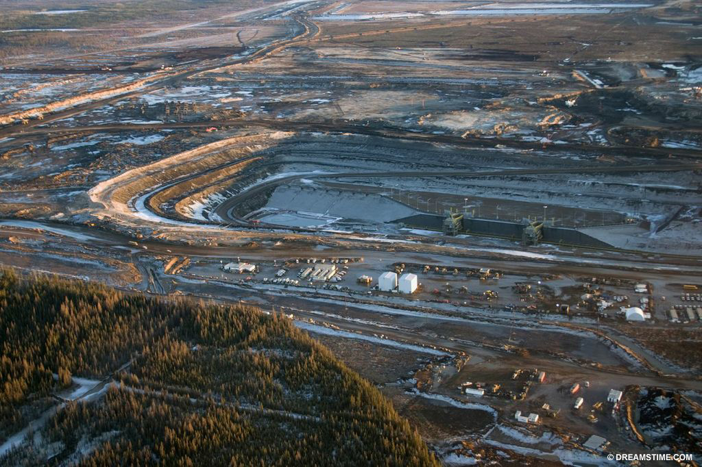 The tar sands lie under 140,000 square kilometres of northern Alberta. Oil sands are loose sand naturally soaked with a form of petroleum, or bitumen.