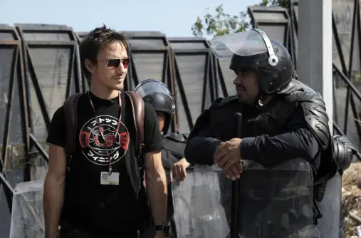 Rob with riot police at the UN climate conference UN CLIMATE CONFERENCE, 16TH SESSION OF THE CONFERENCE OF THE PARTIES (COP 16), . Photo © Tristan Bayer www.earthnative.com From the documentary film Revolution.