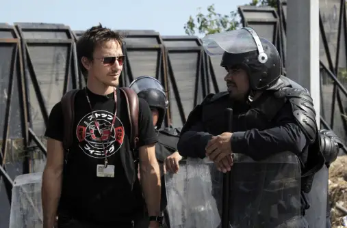 Rob with riot police at the UN climate conference UN CLIMATE CONFERENCE, 16TH SESSION OF THE CONFERENCE OF THE PARTIES (COP 16), . Photo © Tristan Bayer www.earthnative.com From the documentary film Revolution.