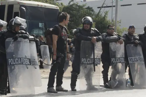 Rob with Riot Police at the UN climate conference COP 16. Photo © Tristan Bayer www.earthnative.com from the documentary film Revolution.
